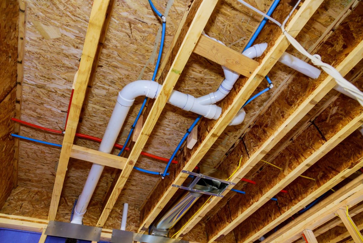 Red and blue PEX water pipes in a house under construction