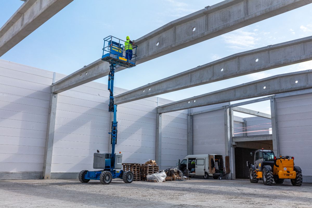 Construction worker on an elevated work platform at an industrial site